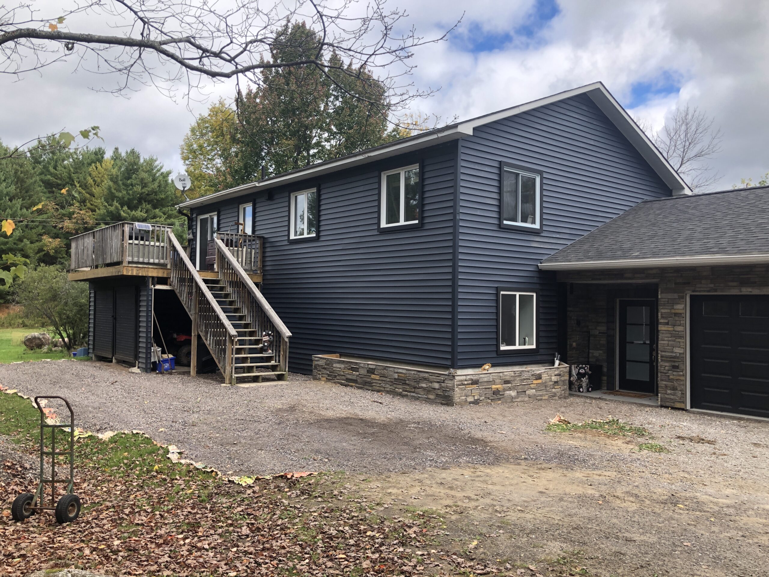 Damaged or weather-worn home siding in North Bay being professionally repaired or replaced to prevent moisture and rot